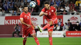 Omar Montassar (R) clears the ball ahead of the Tunisia vs Namibia live stream