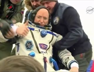 NASA astronaut Scott Kelly gives a thumbs-up sign as he is pulled from his Soyuz spacecraft to end a 340-day mission to the International Space Station. Kelly returned to Earth on a Russian Soyuz capsule with cosmonauts Mikhail Kornienko and Sergey Volkov