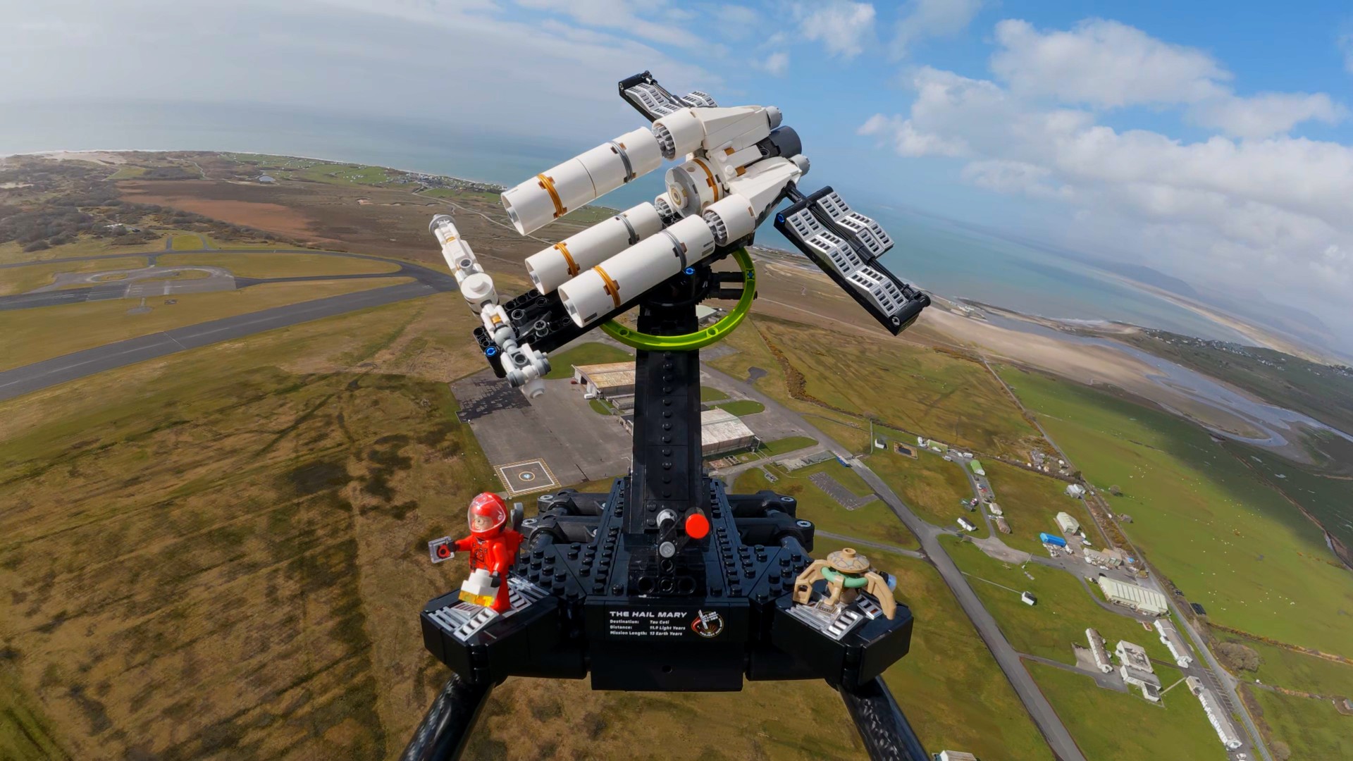 a triangular spacecraft made of white plastic blocks against the backdrop of Earth seen from space