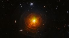 A bright red/orange star shines against dark space