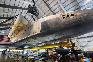Crane operators work with former NASA contractors and a museum curator to carefully open space shuttle Endeavour's payload bay doors inside the Oschin Display Pavilion at the California Science Center in Los Angeles on Tuesday, Feb. 21, 2023.