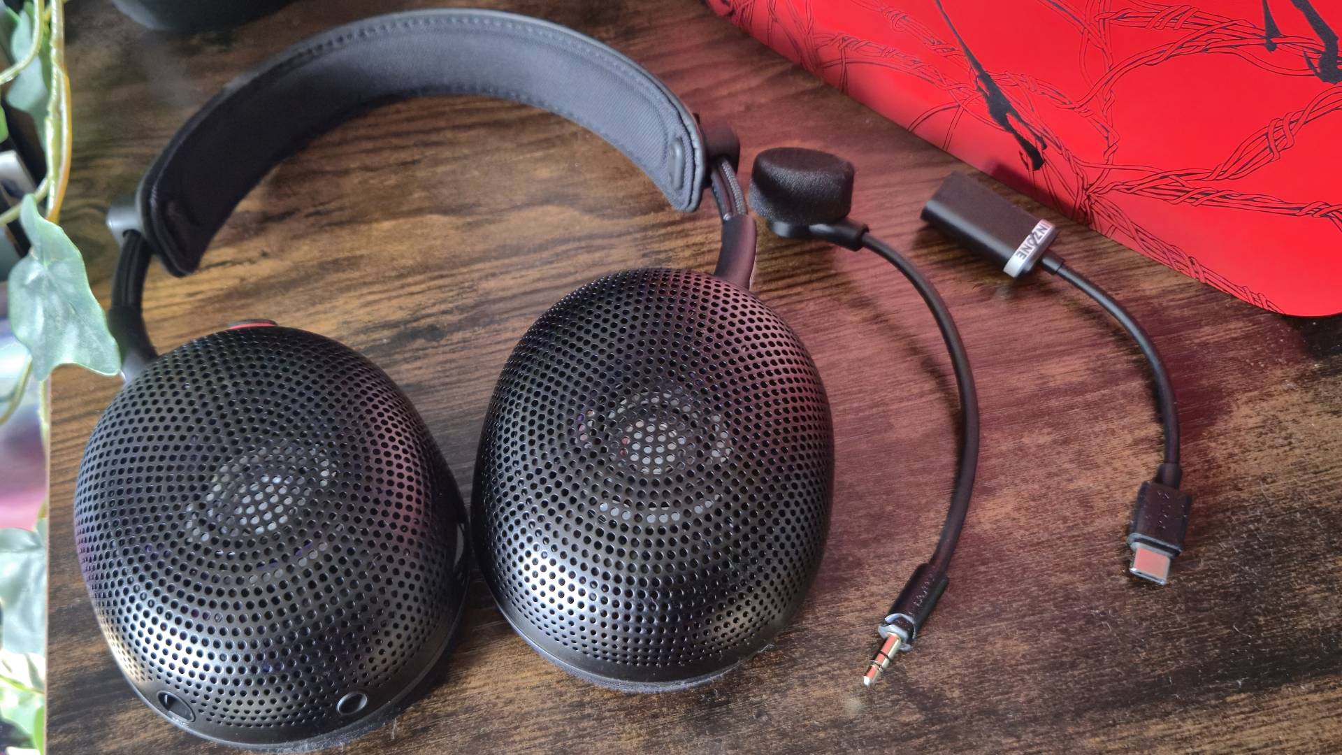 Photo of the Inzone H6 Air headset with its microphone and USB-C Audio Box to its side.