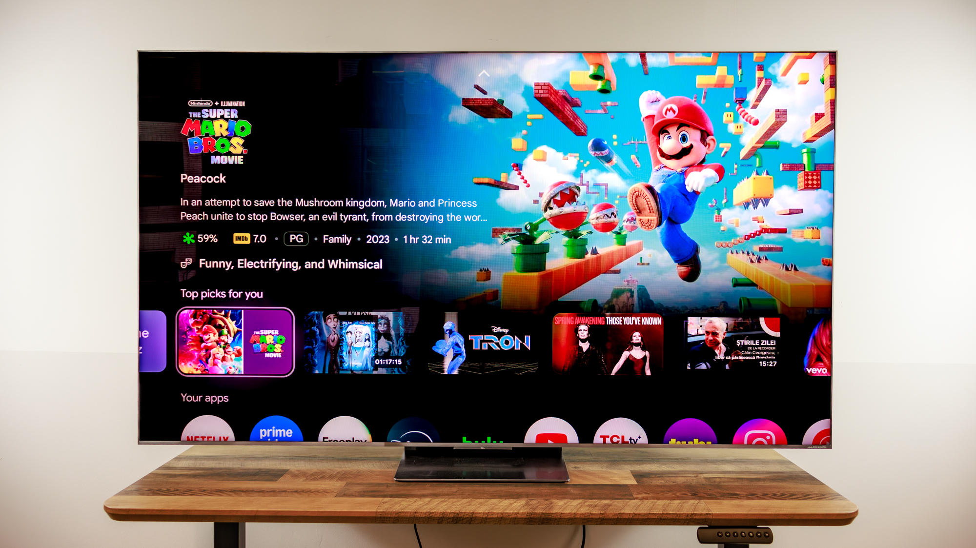 A TCL QM8L TV on a desk