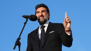 Yasir Al-Rumayyan speaking into a microphone