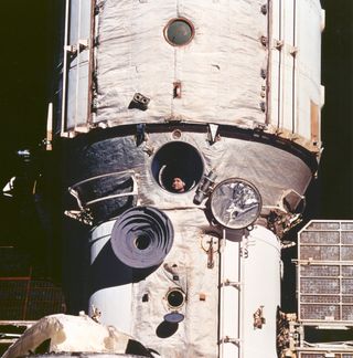 Cosmonaut Valeriy V. Polyakov looks out space station Mir's window during rendezvous operations with the space shuttle Discovery on February 6, 1995. He holds the record for the longest spaceflight, just under 438 days, aboard Mir.