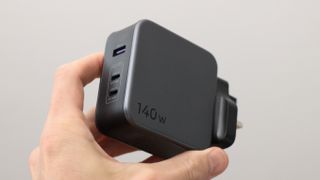 Ugreen Nexode 140W charger held in a hand