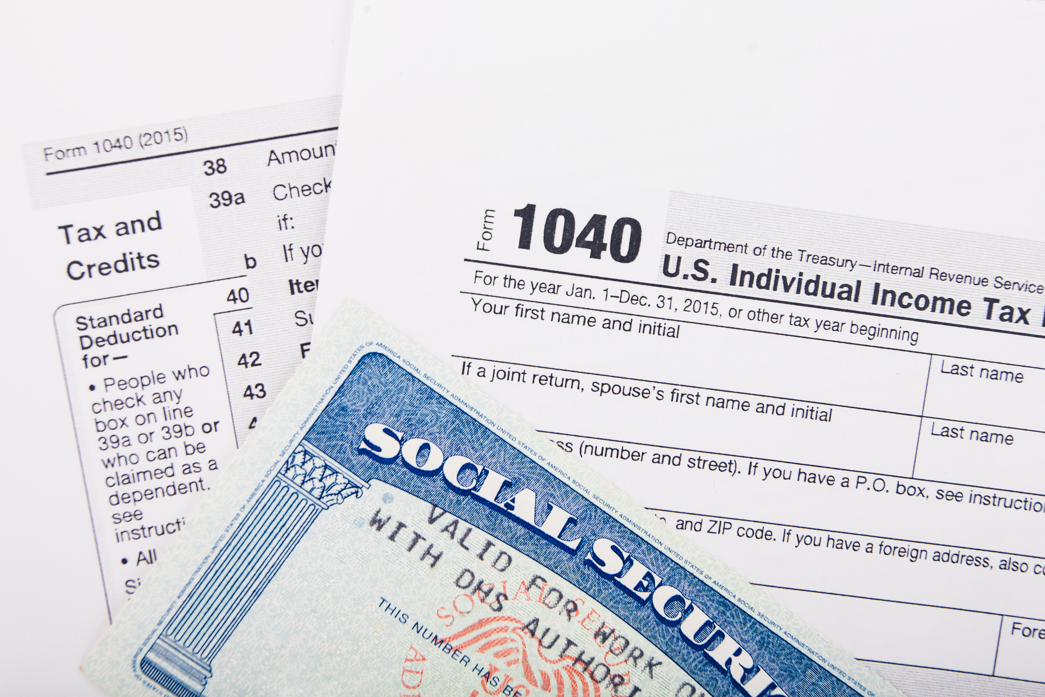 Tax return documents: Form 1040 - U.S. individual income tax return form and Social Security number card.