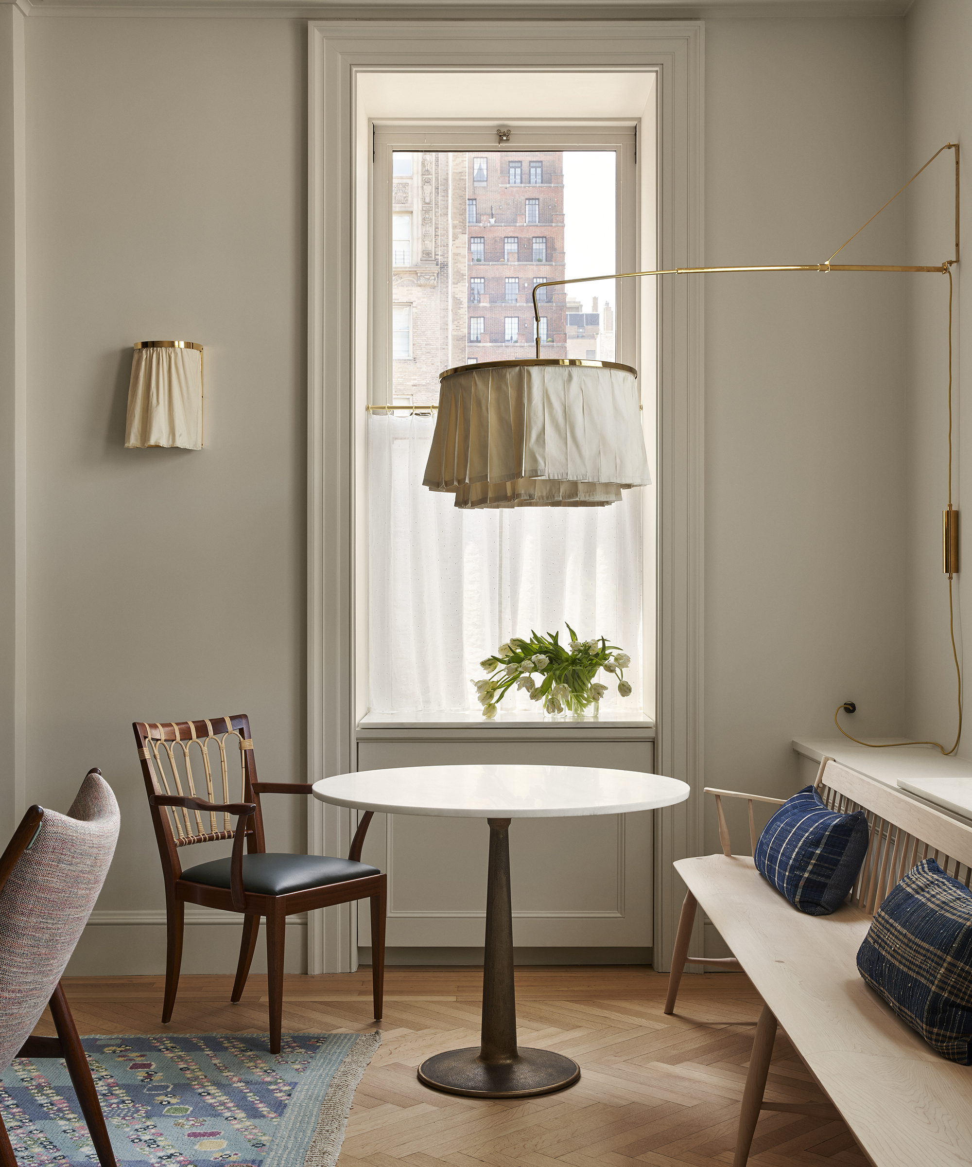 breakfast nook with small round wood table and wood bench