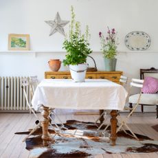 Dining room with vintage furniture, bistro chairs and pots of plants