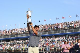 Bryson DeChambeau raises the U.S. Open trophy in the air at the 18th hole during the final round of 124th U.S. Open Championship at Pinehurst No. 2 at Pinehurst Resort on June 16, 2024 in Pinehurst, North Carolina.