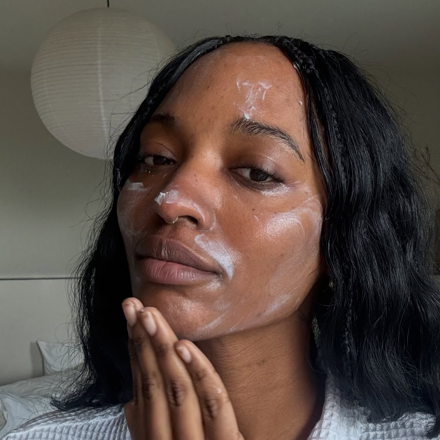 A woman with moisturizer on her skin.