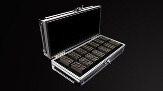 a black-lined suitcase full of 14 gray bricks sits against a black background