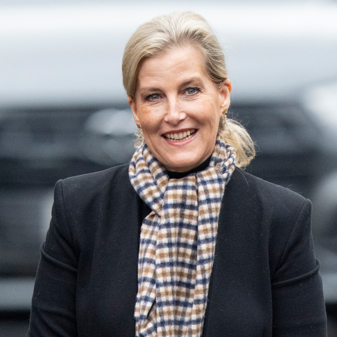 Duchess Sophie wearing a checked scarf and dark coat and smiling