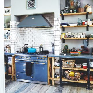 industrial style kitchen with open shelving and blue cooker