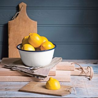 indigo blue walls with lemon in bowl and wooden board