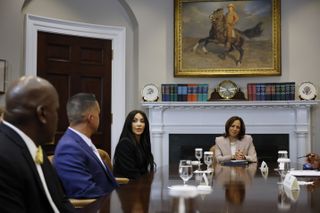 Kim Kardashian (C) joins Vice President Kamala Harris and Jason Hernandez during a roundtable discussion on criminal justice reform in the Roosevelt Room at the White House on April 25, 2024 in Washington, DC.