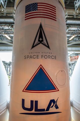 closeup of a white rocket with "ULA" and "US space force" written on its side