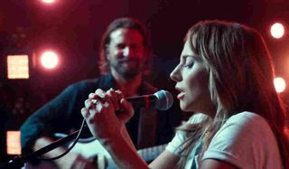 A Star Is Born Lady Gaga sings Shallow with Bradley Cooper in the background in concert