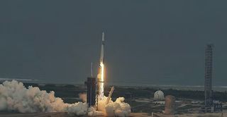 SpaceX rocket lifting off from launch pad