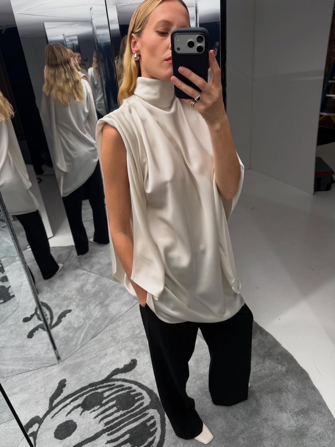 Elly McGaw wearing a silk blouse with black trousers