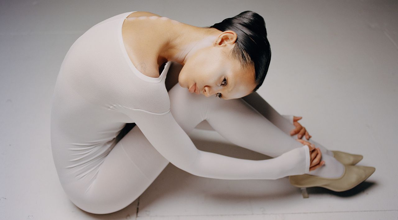 Marcelo Gutierrez make-up on model Jordan Daniels in a white leotard