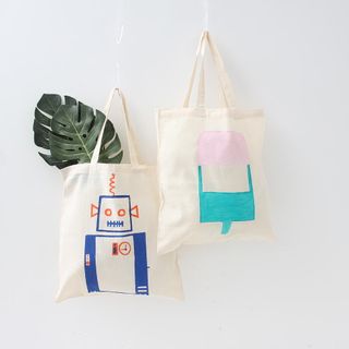 white wall with fabric bags with paints