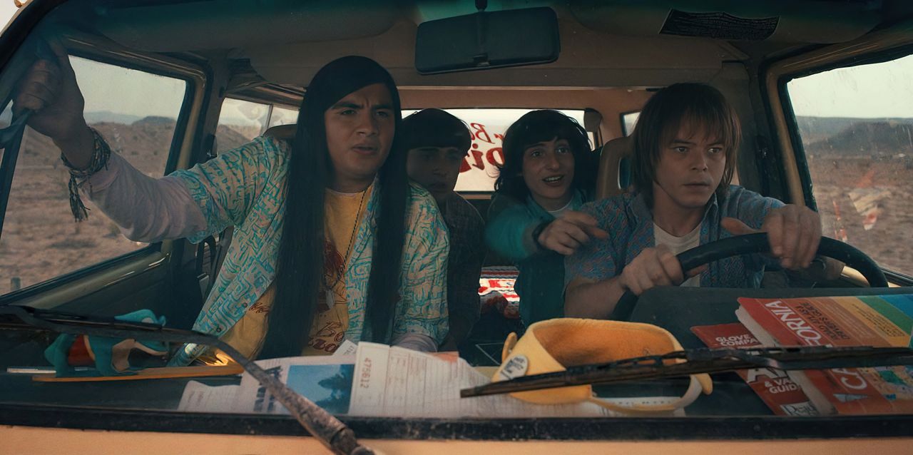 The boys in drive in a van in a press image for Stranger Things 4