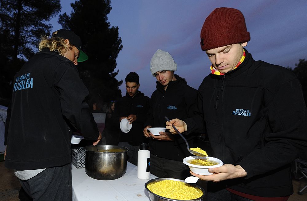 Israel Cycling Academy's hungry riders grab some food on a team camping trip