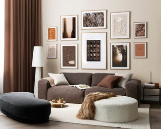 A brown and grey living room with soft upholstered sofa furniture and gallery wall of framed wall art