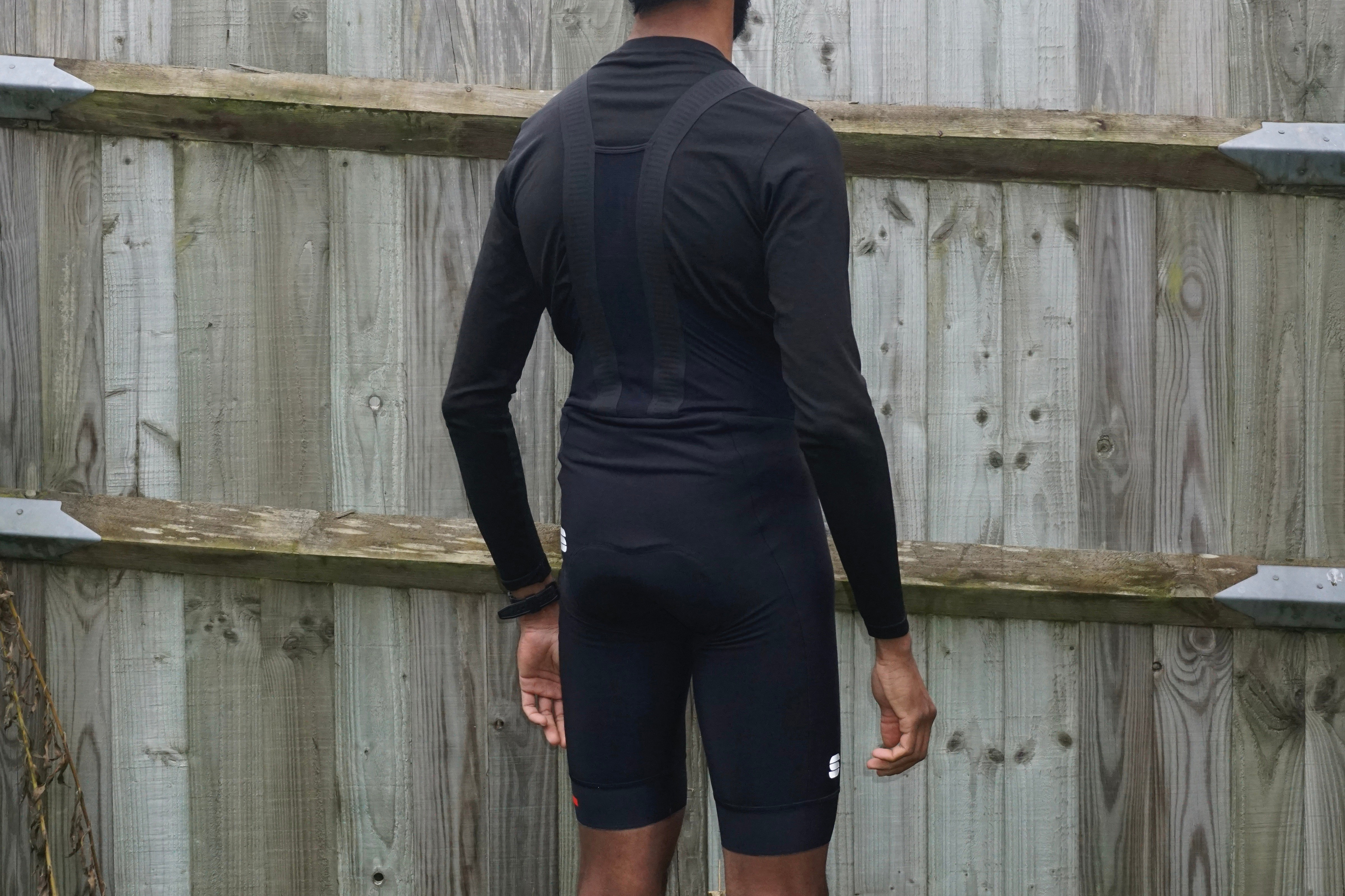 A man poses in a black pair of Sportful Fiandre bib shorts