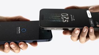 An iPhone transfers money wirelessly to another phone using Tap to Cash in iOS 18