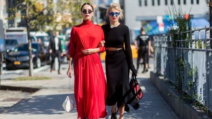 Fashion week attendees wear black dresses