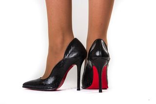 A woman wears high heels.