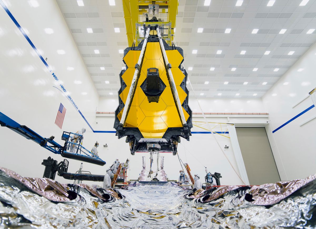 Integration teams carefully guide Webb&rsquo;s suspended telescope section into place above its Spacecraft Element just prior to integration.