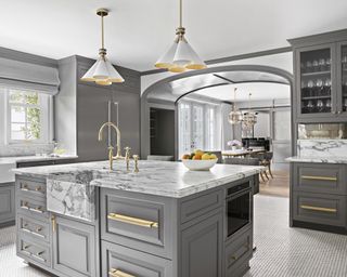 Grey and white kitchen ideas with grey cabinets and island, and a marble backsplash and countertop