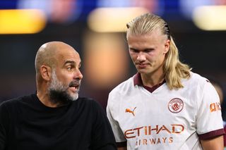 Pep Guardiola the head coach / manager of Manchester City and Erling Haaland of Manchester City during the Premier League match between Burnley FC and Manchester City at Turf Moor on August 11, 2023 in Burnley, England.