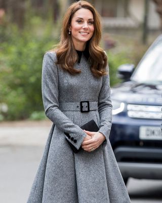Kate Middleton wearing a grey midi dress with pleats