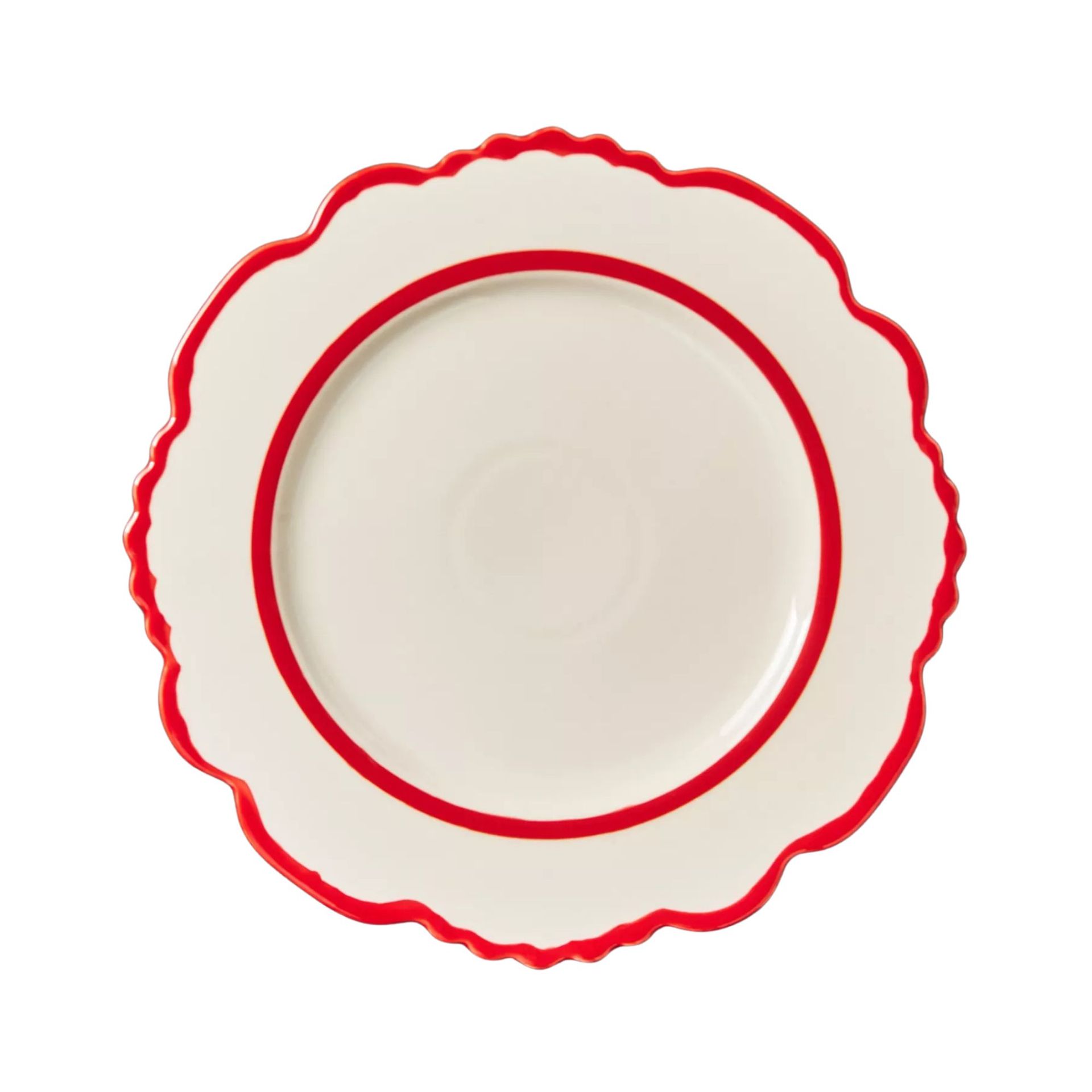 A white plate with a frilly red trim