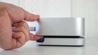 A picture showing how Satechi's hub and stand for the Mac mini M4 allows you to easily reach its power button