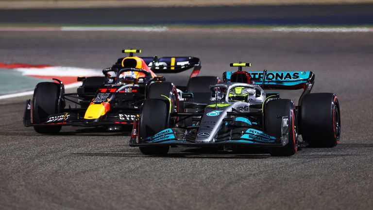Lewis Hamilton of Great Britain driving the (44) Mercedes AMG Petronas F1 Team W13 leads Sergio Perez of Mexico driving the (11) Oracle Red Bull Racing RB18 during the F1 Grand Prix of Bahrain at Bahrain International Circuit