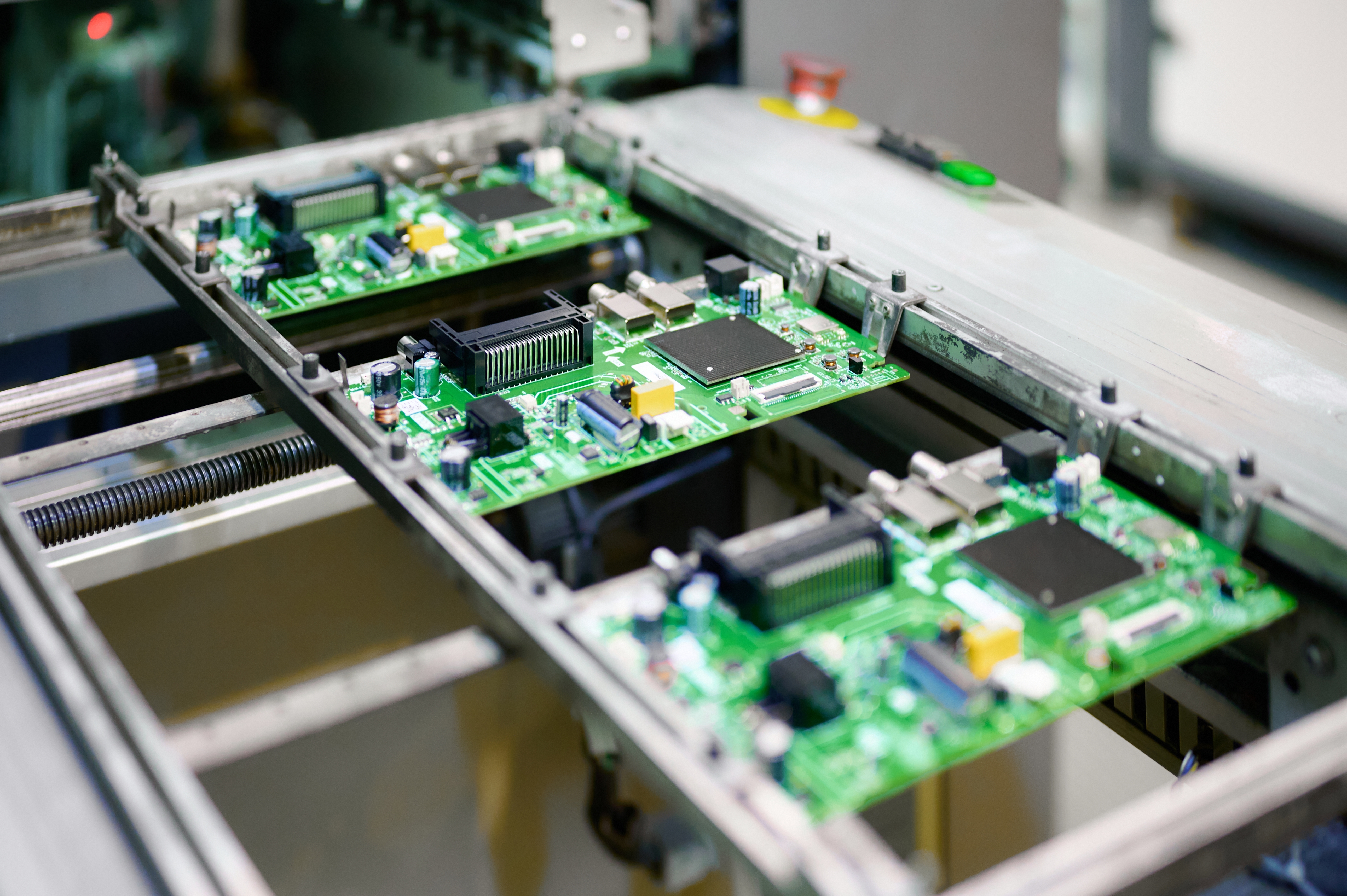 Electronic circuit boards moving along a conveyor system in a manufacturing facility for assembly and quality control