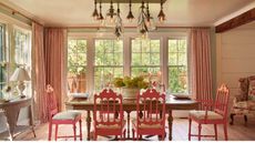 Dining room with large windows featuring a table and chairs bought at an estate sale