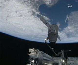 Amazing view of SpaceX Dragon space capsule backdropped by the Earth during docking operations on March 3, 2013.