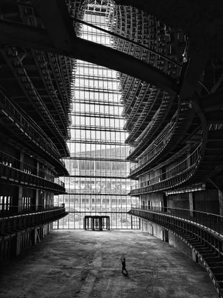 Lone figure is dwarfed by giant indoor space