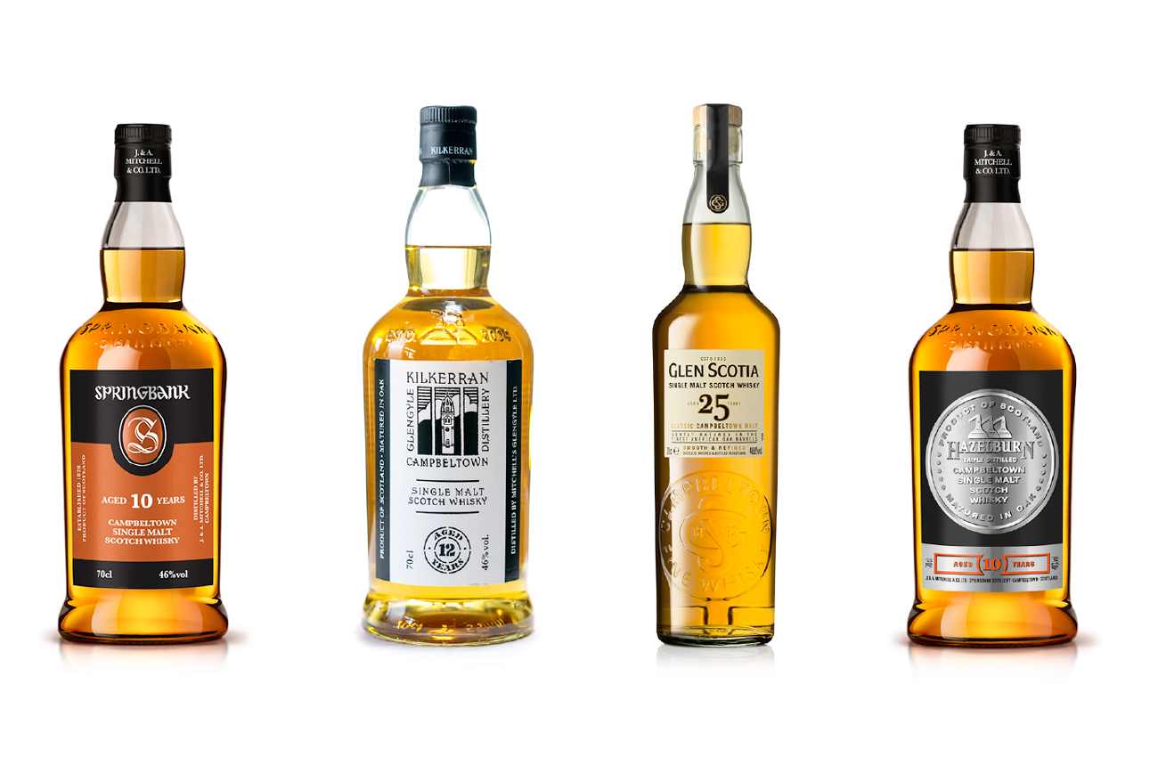 Four bottles of whisky against a white background