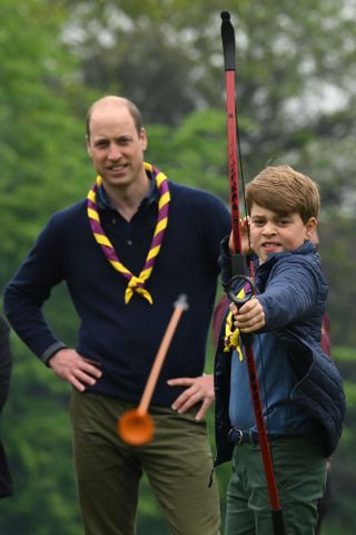 Prince William and Prince George doing archery