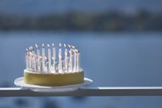 birthday cake with candles on a ledge