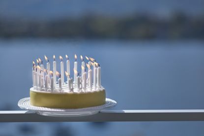 birthday cake with candles on a ledge