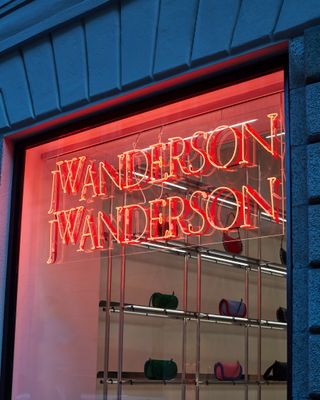 Neon lights which read JW Anderson in window of Milan store