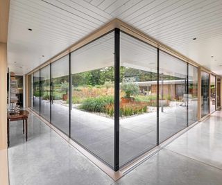 Contemporary home with two walls of fixed glazing and sliding doors overlooking a landscaped courtyard.